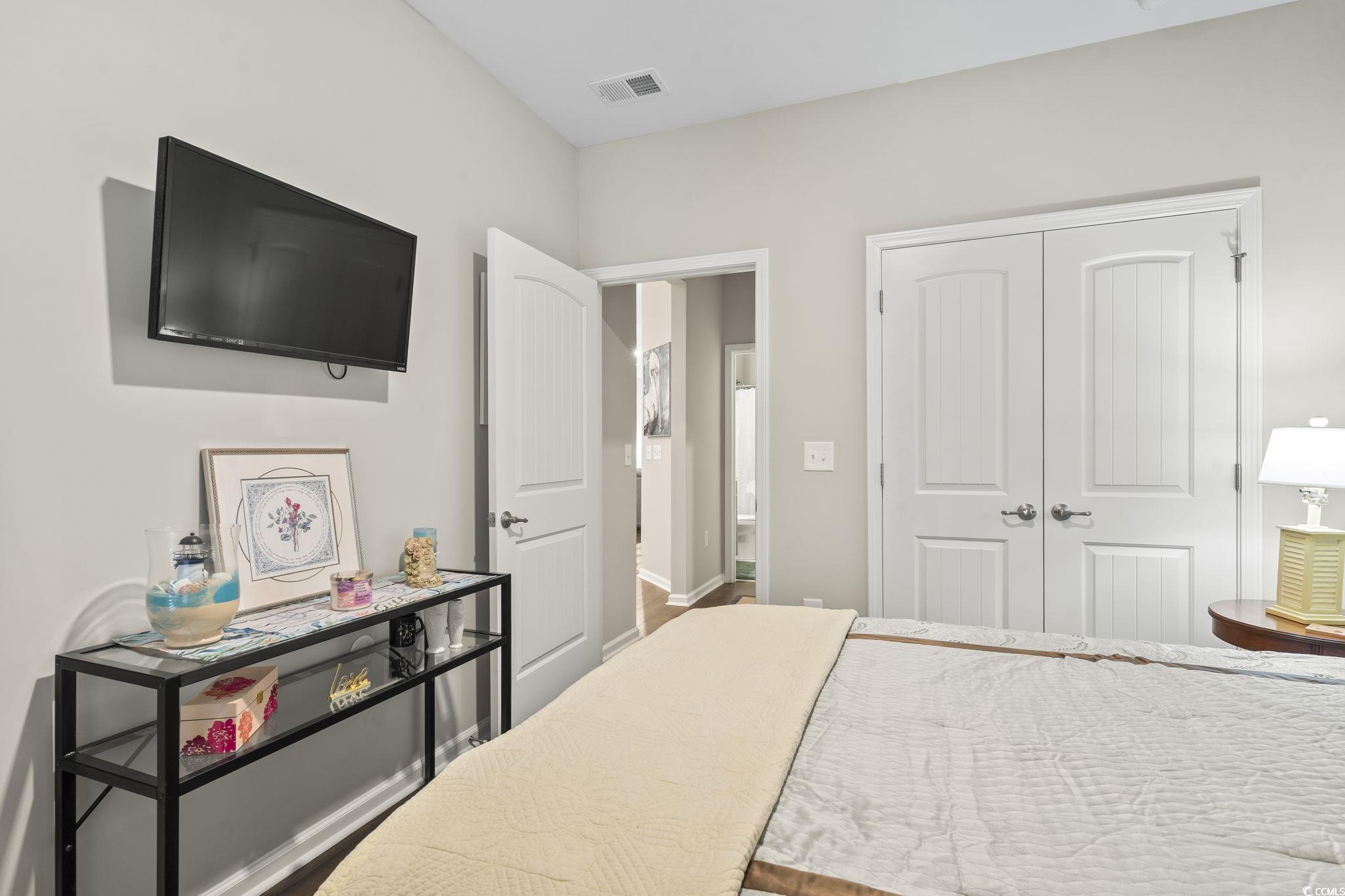 4040 Taranto Loop, Unit 5303C Myrtle Beach, SC 29579 - Photo 19 of 38 Bedroom featuring a closet and wood finished floors