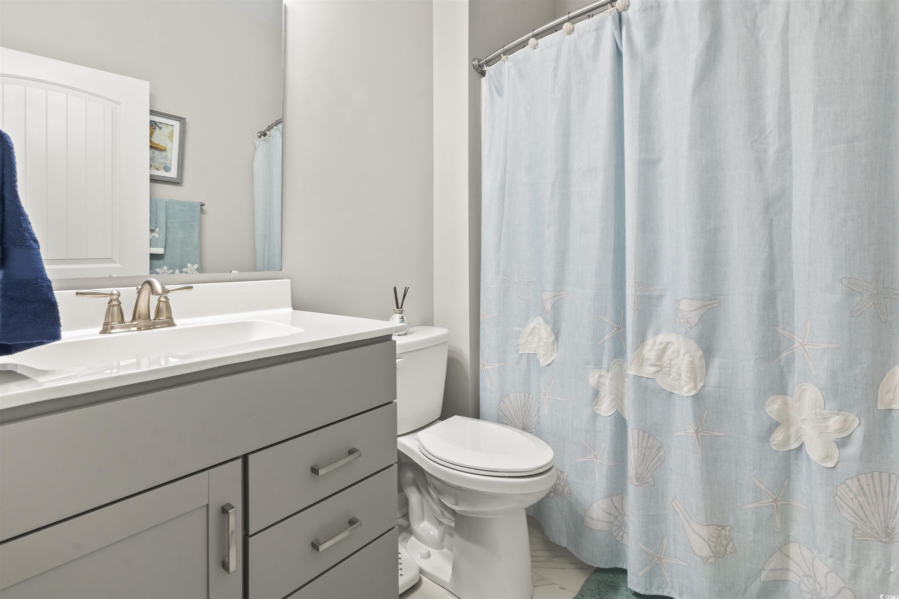 4040 Taranto Loop, Unit 5303C Myrtle Beach, SC 29579 - Photo 20 of 38 Full bathroom with vanity and curtained shower