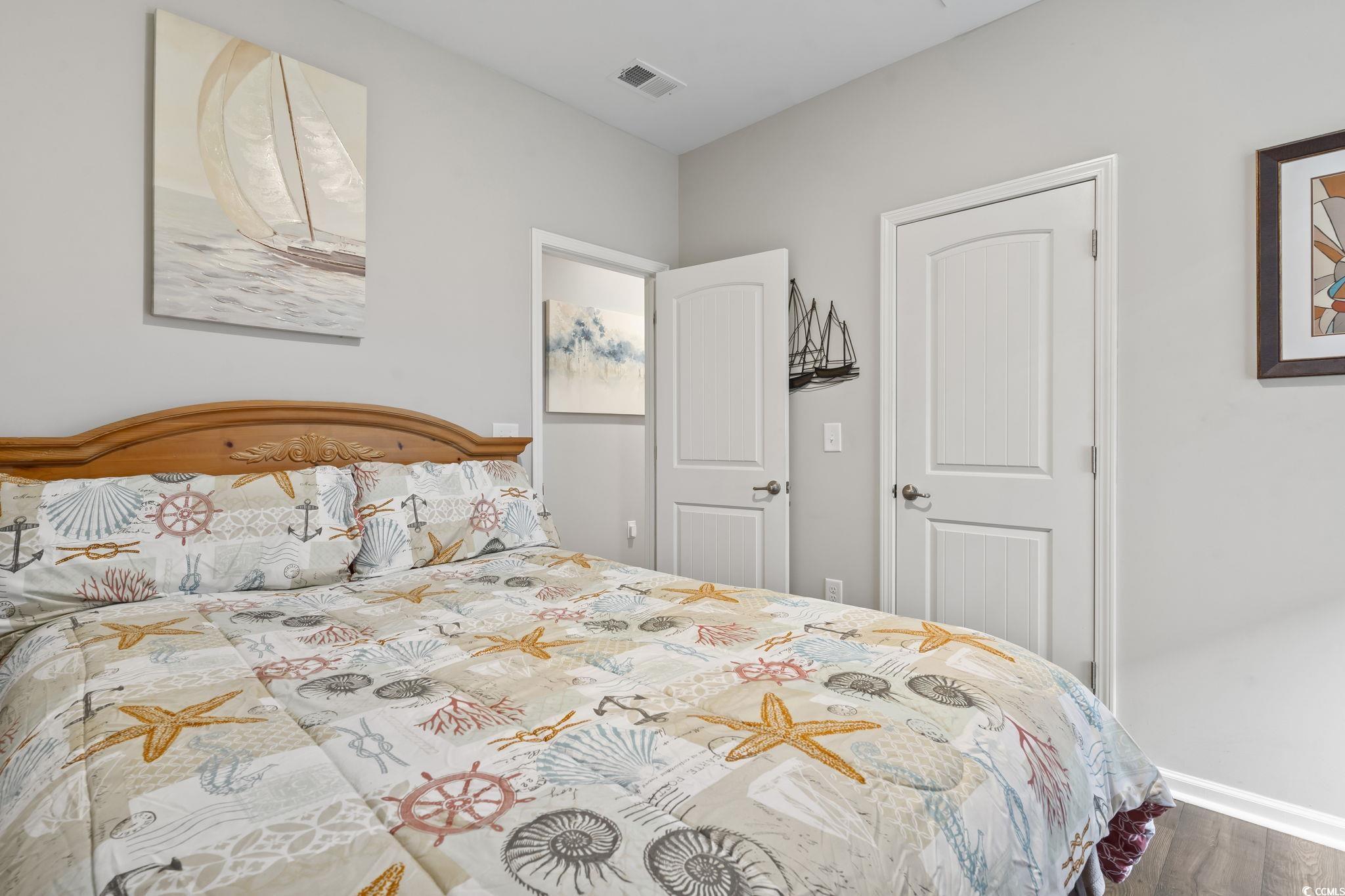 4040 Taranto Loop, Unit 5303C Myrtle Beach, SC 29579 - Photo 21 of 38 Bedroom featuring wood finished floors and baseboards