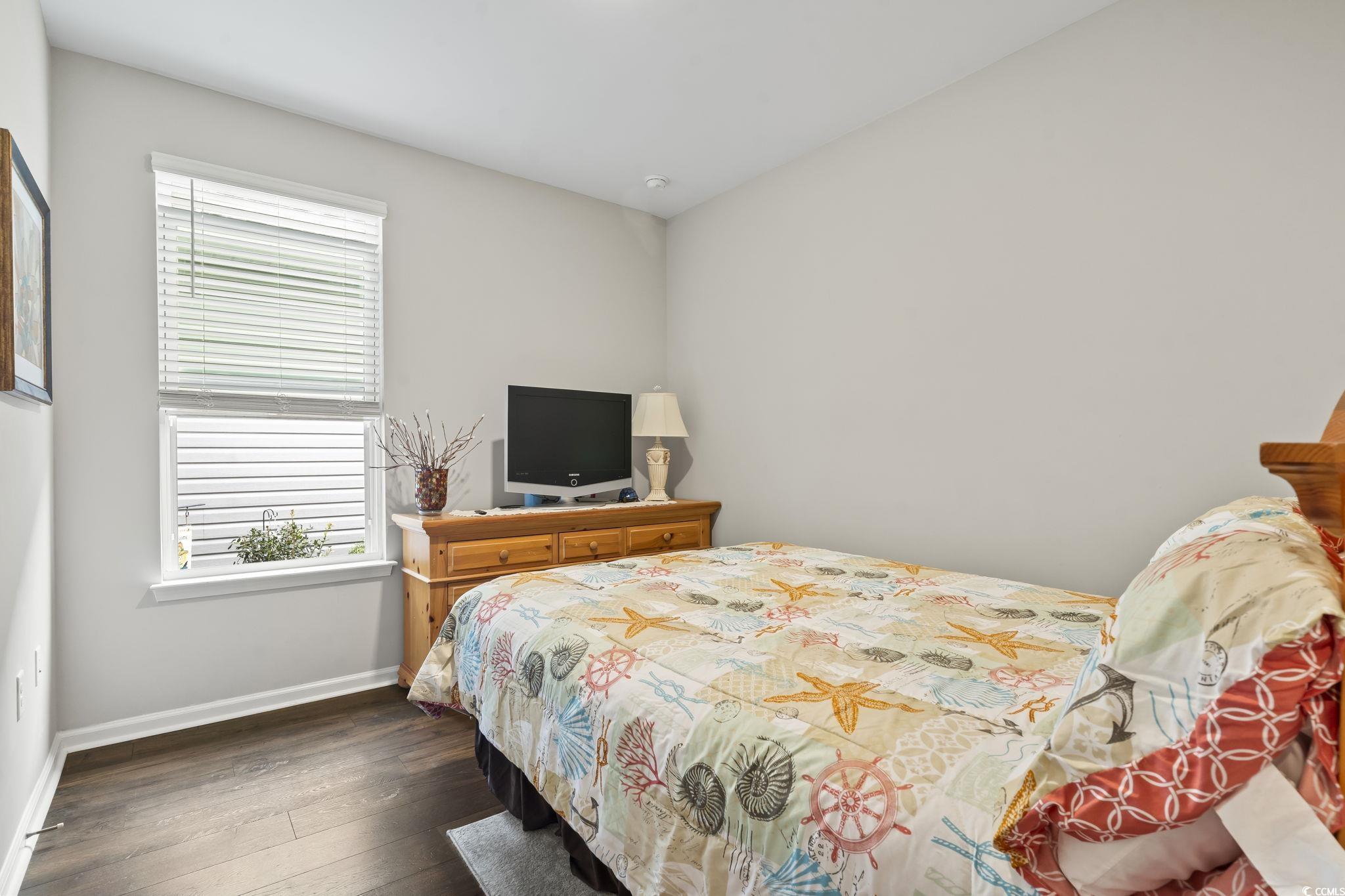 4040 Taranto Loop, Unit 5303C Myrtle Beach, SC 29579 - Photo 22 of 38 Bedroom featuring dark wood finished floors and baseboards