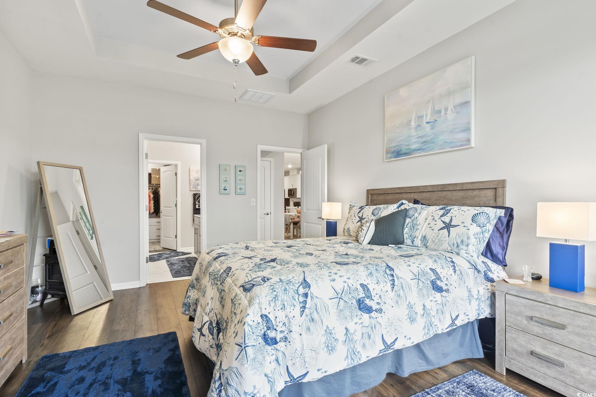 4040 Taranto Loop, Unit 5303C Myrtle Beach, SC 29579 - Photo 24 of 38 Bedroom featuring a raised ceiling, dark wood-style floors, and a ceiling fan
