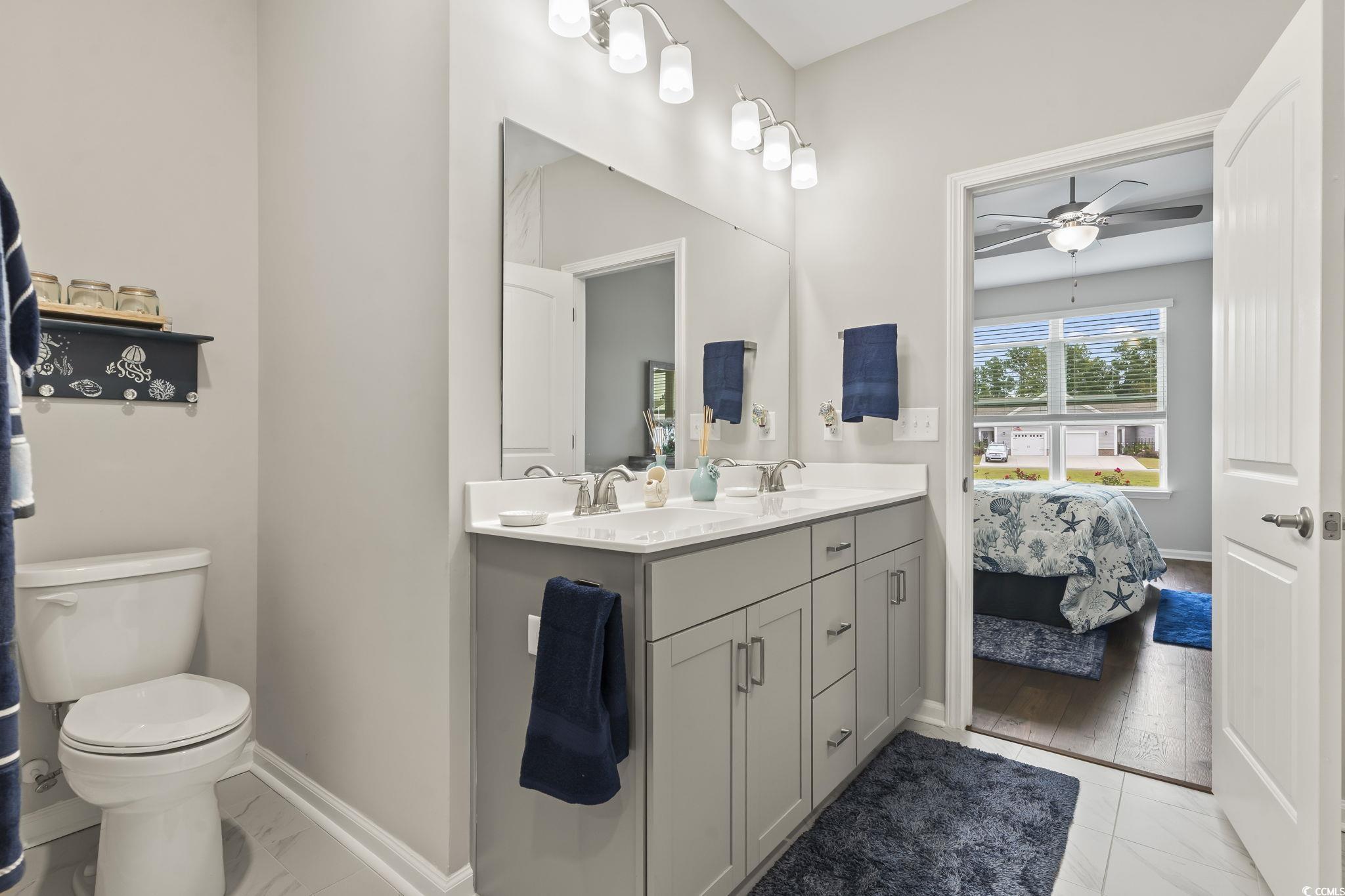 4040 Taranto Loop, Unit 5303C Myrtle Beach, SC 29579 - Photo 26 of 38 Full bath with double vanity, connected bathroom, ceiling fan, and light marble finish flooring