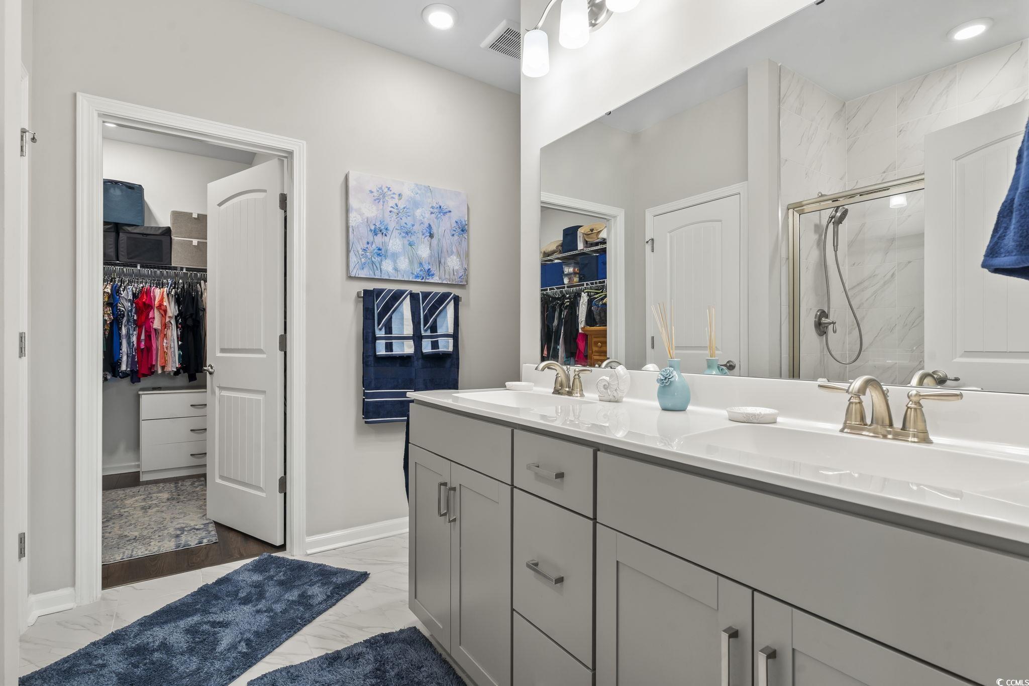 4040 Taranto Loop, Unit 5303C Myrtle Beach, SC 29579 - Photo 27 of 38 Full bathroom with a walk in closet, a marble finish shower, double vanity, light marble finish floors, and recessed lighting