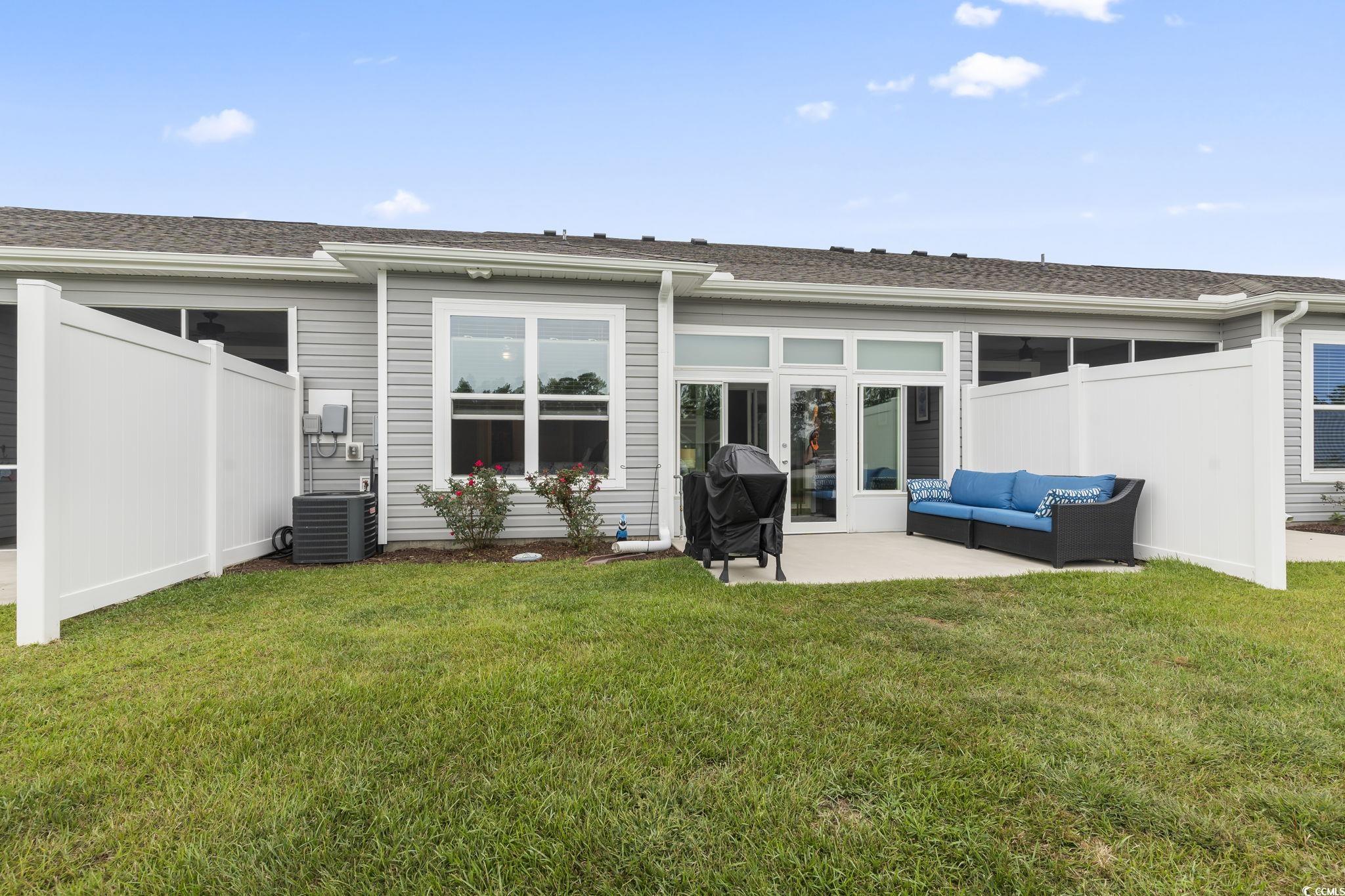 4040 Taranto Loop, Unit 5303C Myrtle Beach, SC 29579 - Photo 31 of 38 Back of property featuring roof with shingles, outdoor lounge area, and a patio area