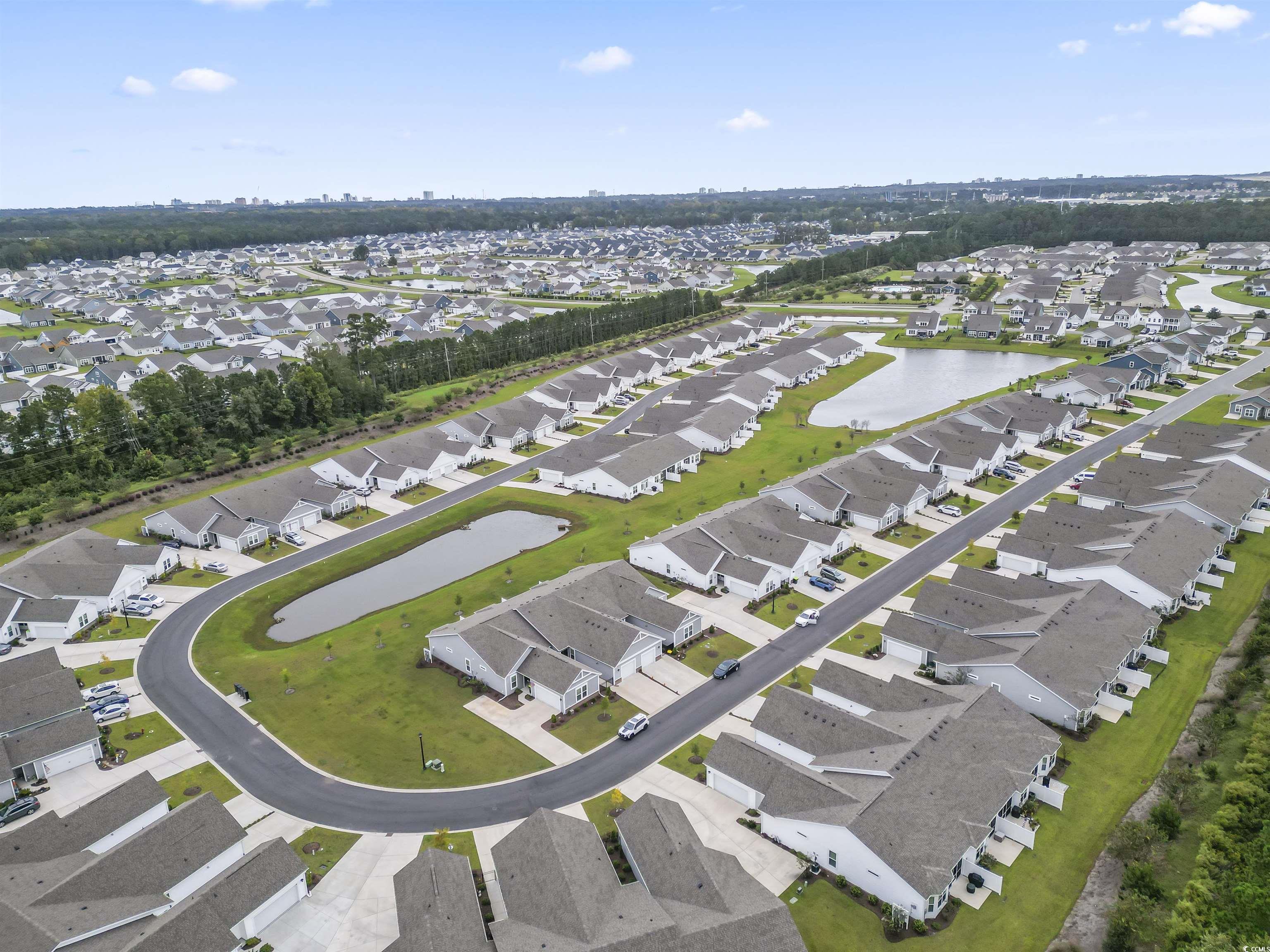 4040 Taranto Loop, Unit 5303C Myrtle Beach, SC 29579 - Photo 33 of 38 Aerial overview of property's location with a large body of water and nearby suburban area