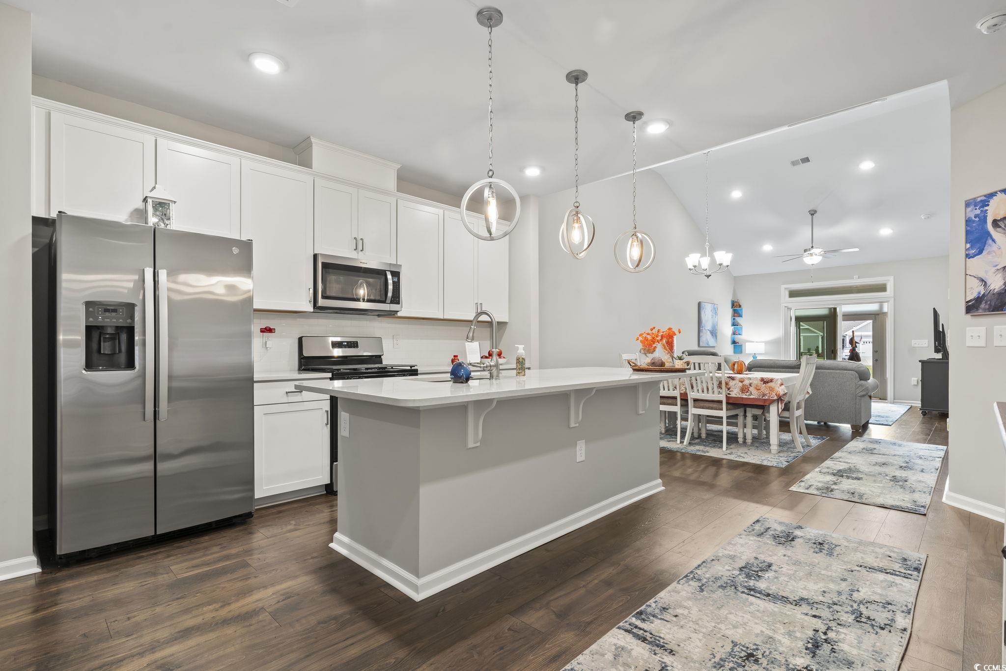 4040 Taranto Loop, Unit 5303C Myrtle Beach, SC 29579 - Photo 5 of 38 Kitchen featuring stainless steel appliances, dark wood-type flooring, white cabinets, decorative light fixtures, and recessed lighting