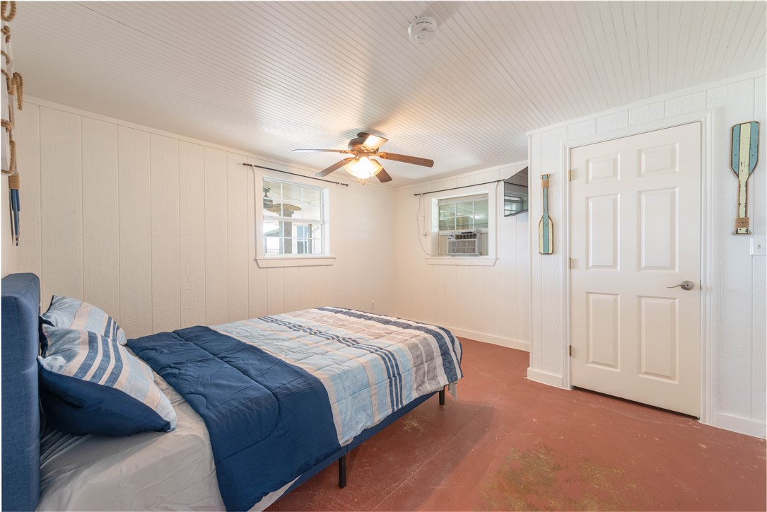 132 Zenna Drive Mathis, TX 78368 - Photo 26 of 40 a bedroom with a bed and a chandelier