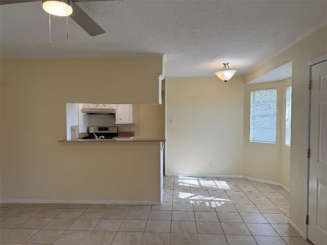a view of a refrigerator a microwave and a sink