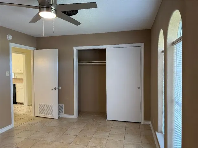 a view of a livingroom with a ceiling fan and a window