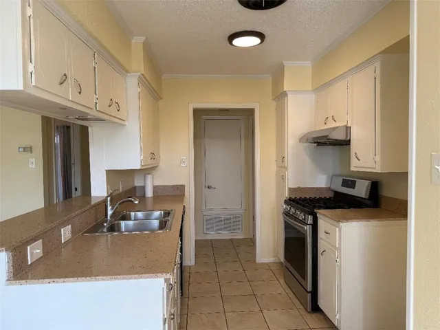 a kitchen with stainless steel appliances granite countertop a stove and a sink