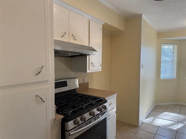 a kitchen with granite countertop a stove and a refrigerator