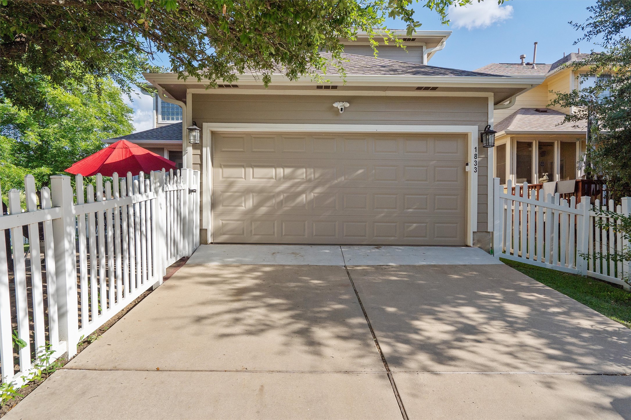1833 Thompson Trail Round Rock, TX 78664 - Photo 36 of 40 A classic white picket fence encloses a charming yard next to a spacious attached garage.