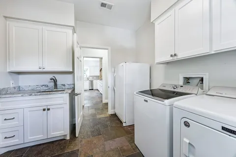a kitchen with a sink a stove and refrigerator