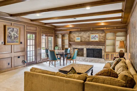 a living room with furniture and a potted plant