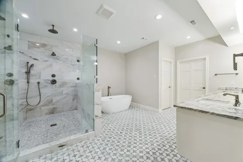 a bathroom with a sink toilet and shower