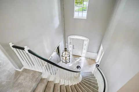 a view of a hallway view with staircase