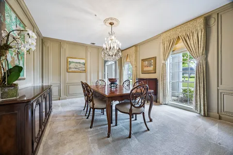 a view of a dining room with furniture and window