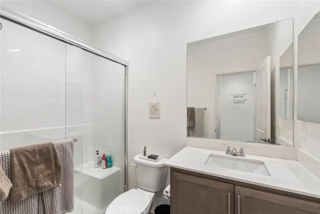 a bathroom with a sink vanity mirror and toilet