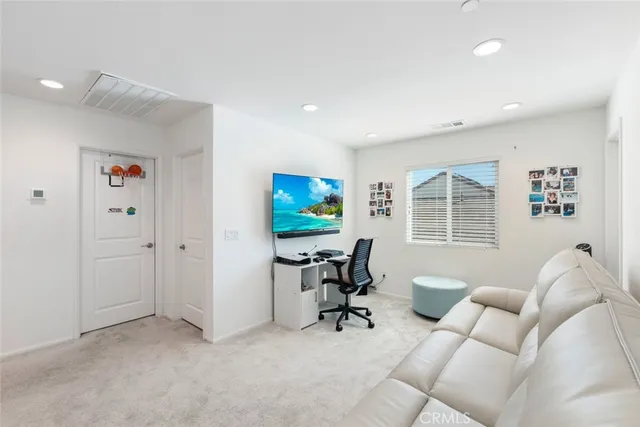 a view of a livingroom with workspace and a couch