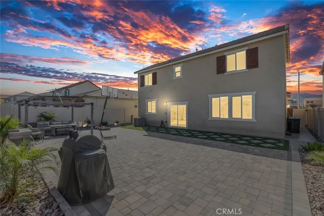 a view of a house with backyard and sitting area