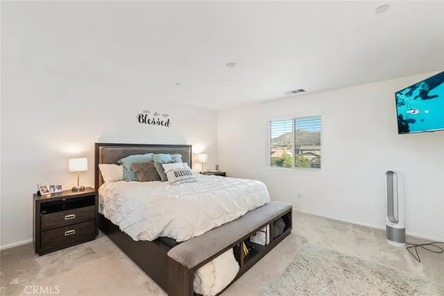 a bedroom with a bed and a tv