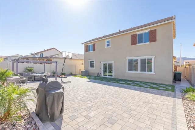 a view of a backyard with furniture and a fire pit