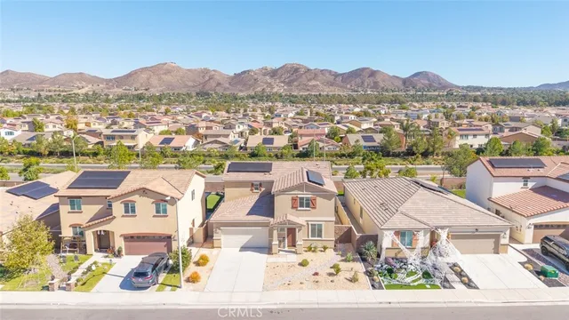 an aerial view of residential houses with outdoor space and river