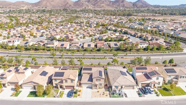 an aerial view of residential houses with outdoor space and trees