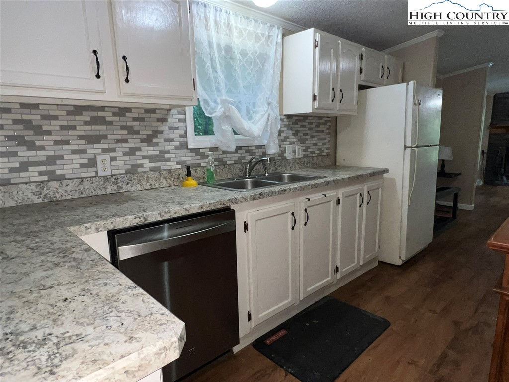1980 Mountaindale Road Vilas, NC 28692 - Photo 11 of 25 a kitchen with stainless steel appliances granite countertop a sink stove and refrigerator