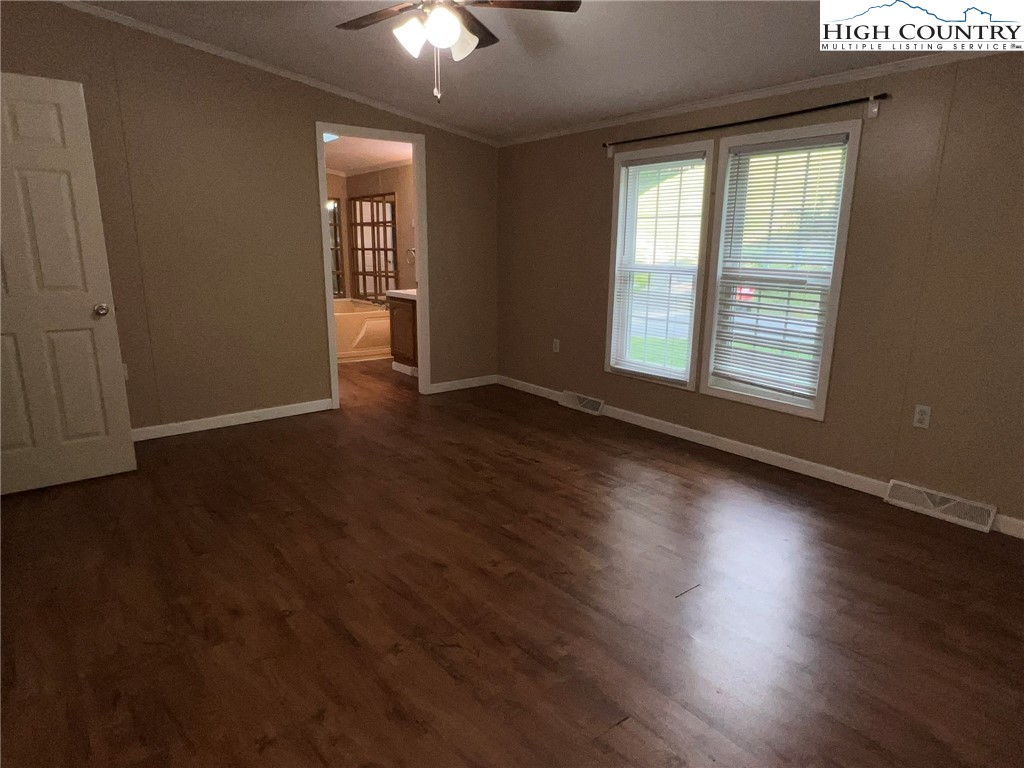 1980 Mountaindale Road Vilas, NC 28692 - Photo 13 of 25 an empty room with wooden floor and windows