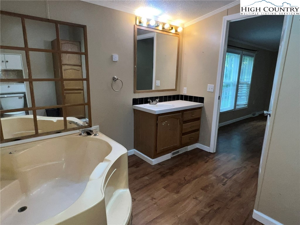 1980 Mountaindale Road Vilas, NC 28692 - Photo 18 of 25 a bathroom with a tub sink and mirror
