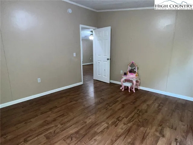 a view of a room with wooden floor and lounge chairs