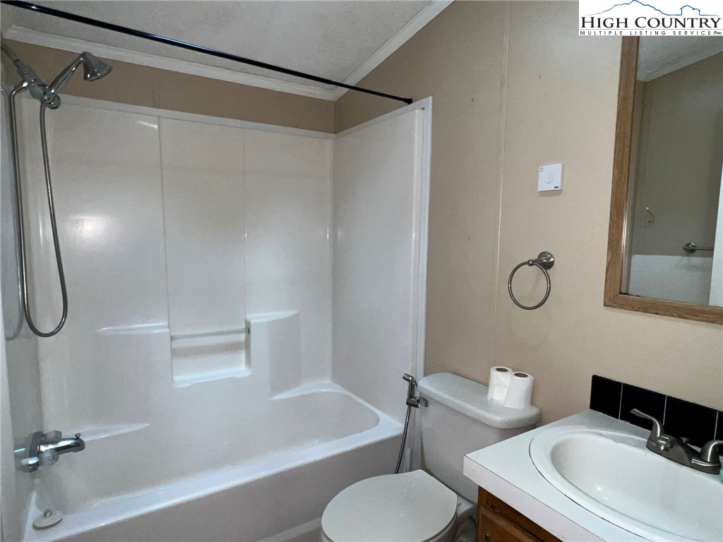 1980 Mountaindale Road Vilas, NC 28692 - Photo 25 of 25 a bathroom with a granite countertop bathtub sink vanity mirror and toilet