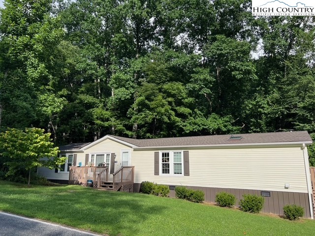 1980 Mountaindale Road Vilas, NC 28692 - Photo 3 of 25 a front view of a house with a yard and green space