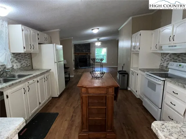 a kitchen with sink stove and refrigerator
