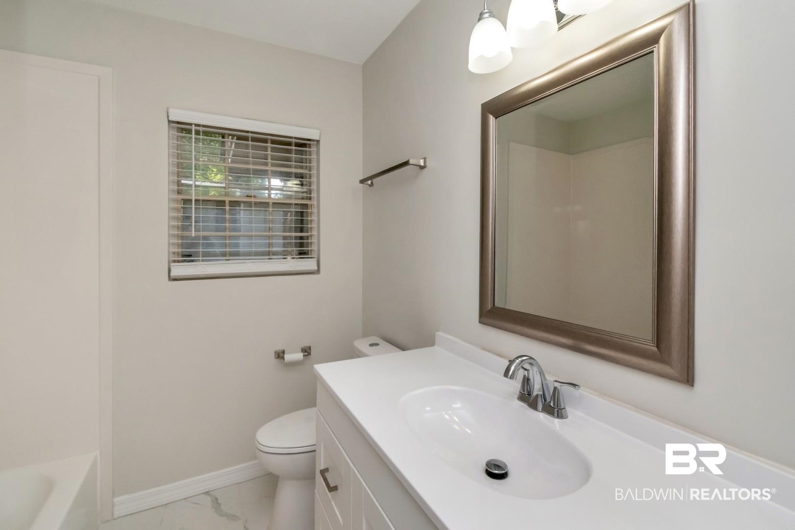 2105 Upham Court Mobile, AL 36607 - Photo 19 of 32 Full bath featuring vanity, light marble finish flooring, and shower combination