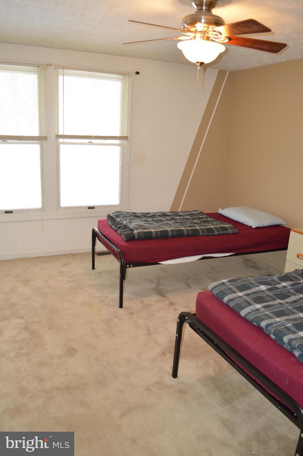 6111 Western Run Drive Baltimore, MD 21209 - Photo 17 of 27 a bedroom with a bed and a chandelier