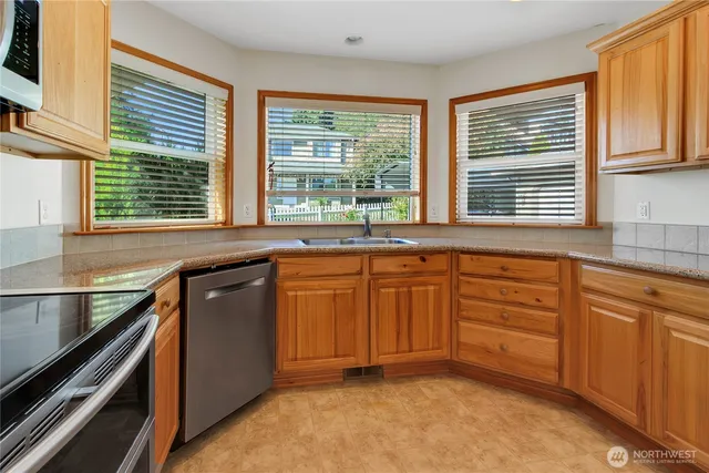 a kitchen with granite countertop a sink and a window
