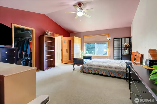 a spacious bedroom with a bed and a chandelier