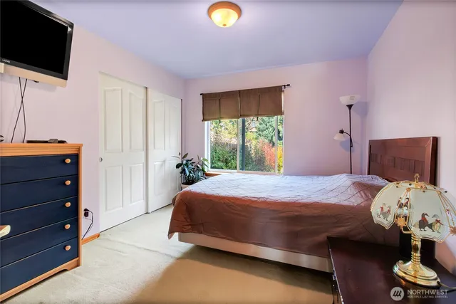 a bedroom with a bed and flat screen tv