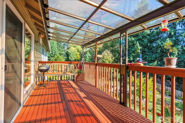 a view of a backyard with wooden fence and a large tree