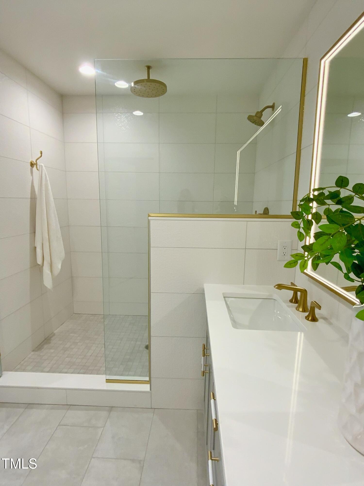 3838 Regent Road Durham, NC 27707 - Photo 38 of 55 a bathroom with a tub a sink and shower