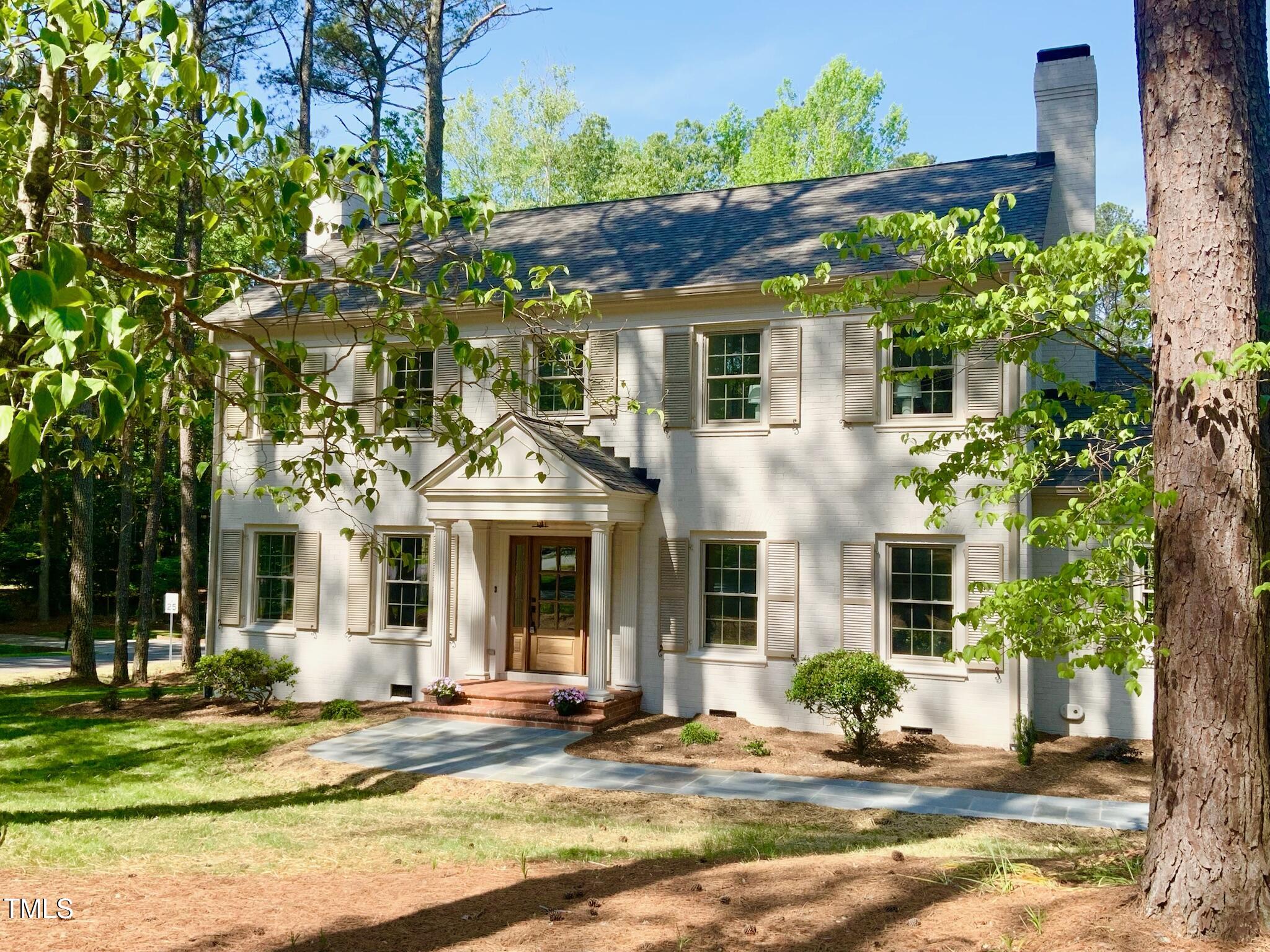 3838 Regent Road Durham, NC 27707 - Photo 4 of 55 a front view of a house with a garden
