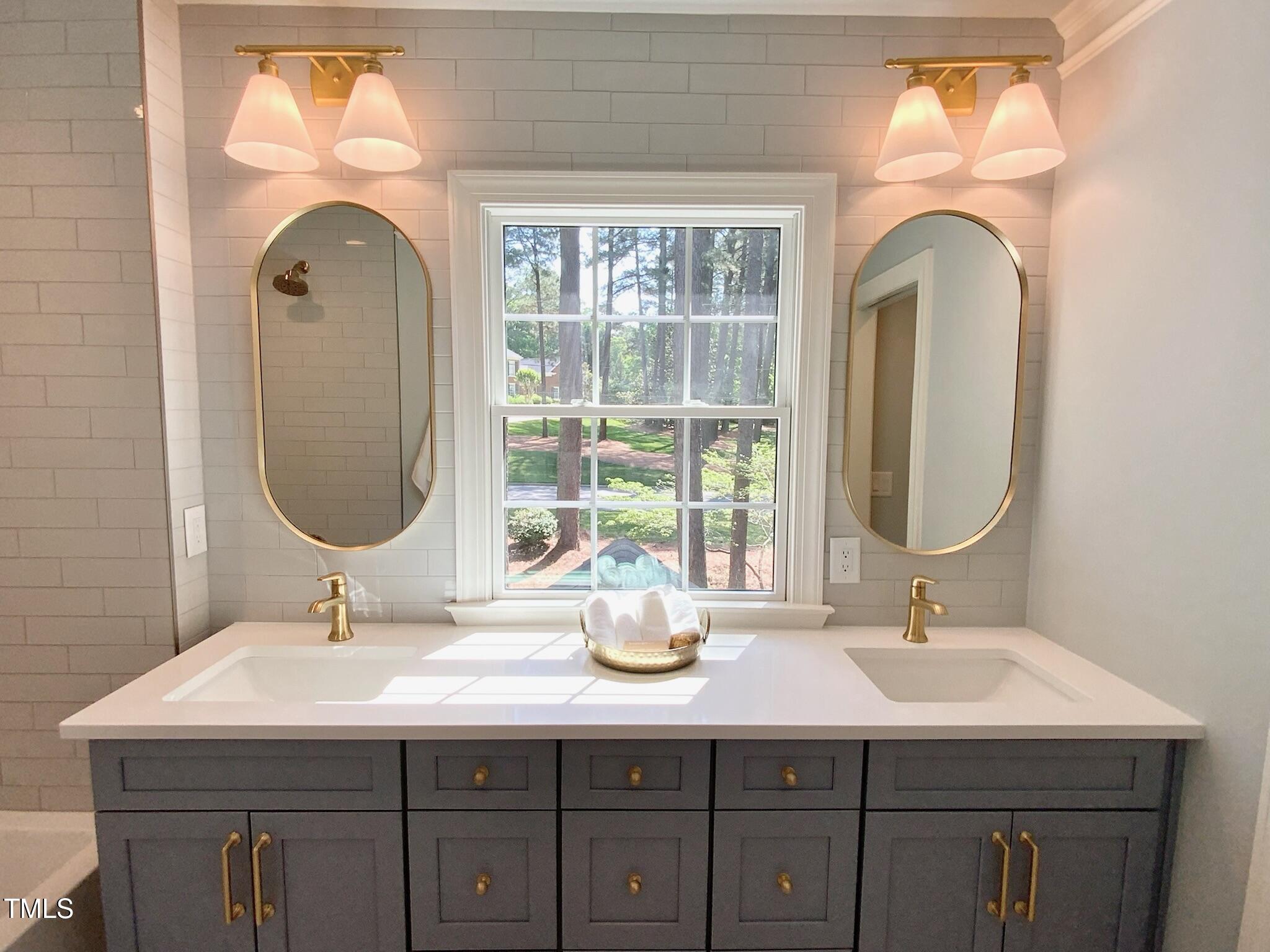 3838 Regent Road Durham, NC 27707 - Photo 43 of 55 a bathroom with a sink and a mirror