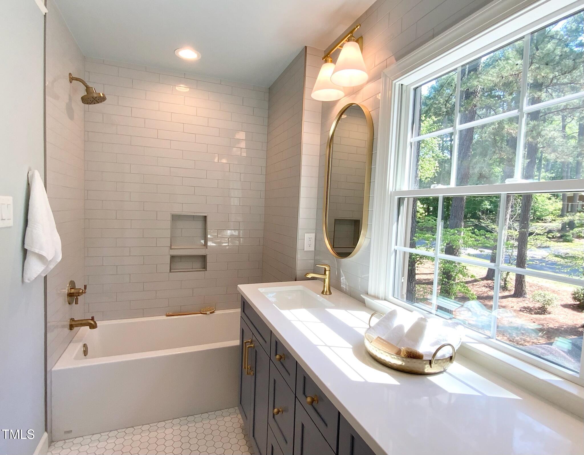3838 Regent Road Durham, NC 27707 - Photo 45 of 55 a bathroom with a granite countertop sink and a large mirror
