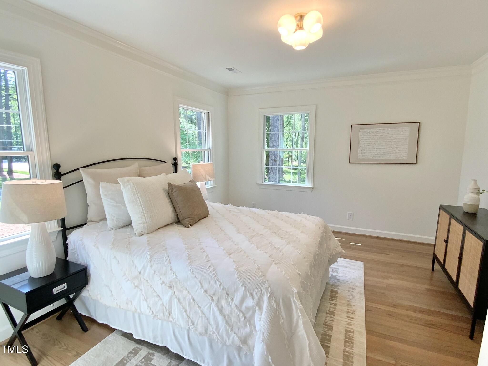 3838 Regent Road Durham, NC 27707 - Photo 46 of 55 a bedroom with a bed and wooden floor