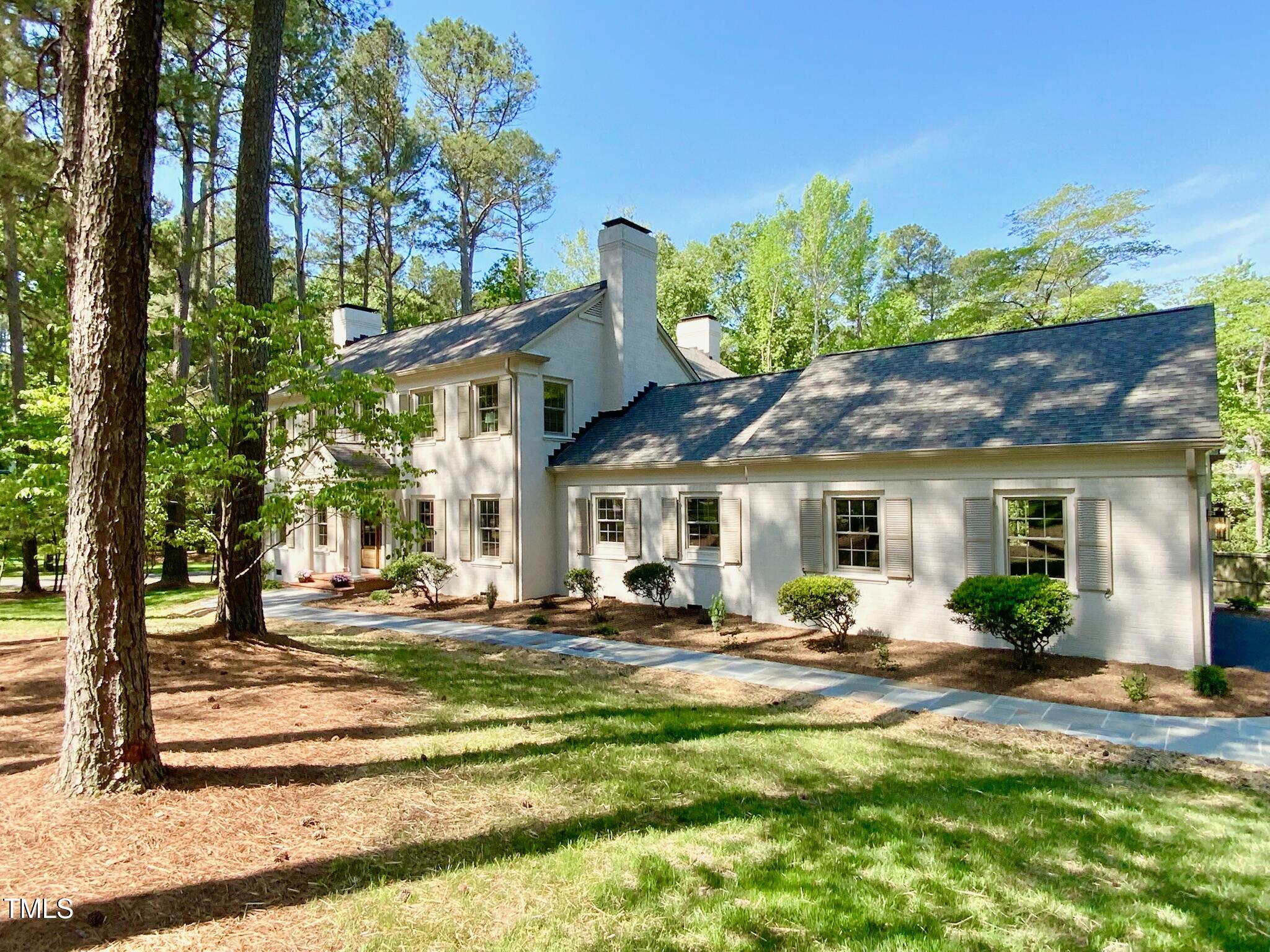 3838 Regent Road Durham, NC 27707 - Photo 6 of 55 a front view of a house with a yard table and chairs