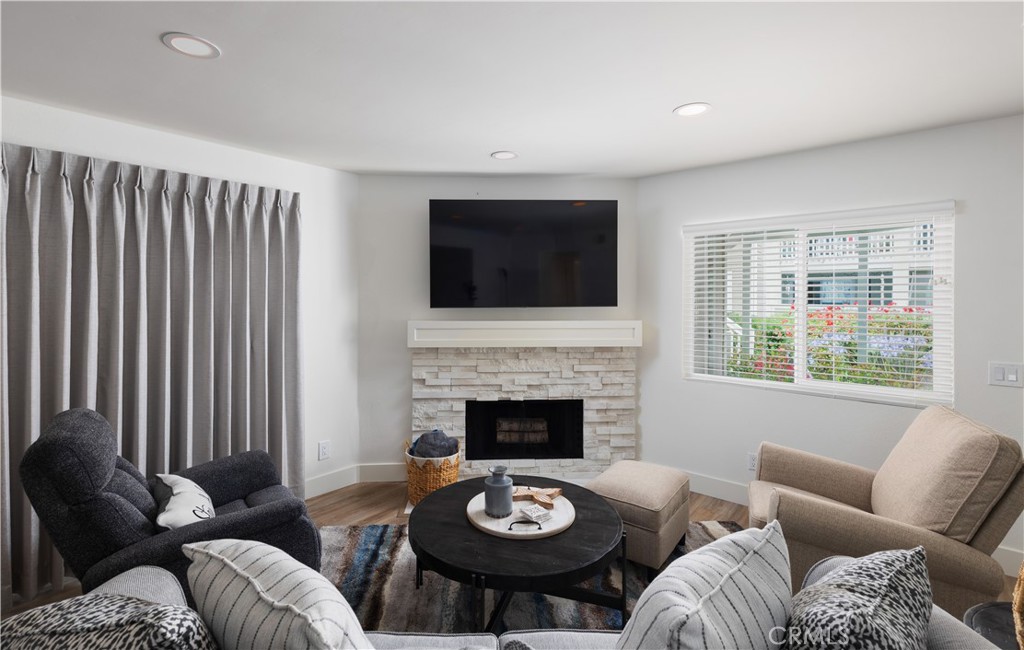 34116 Selva Road, Unit 308 Dana Point, CA 92629 - Photo 11 of 29 a living room with furniture a fireplace and a flat screen tv