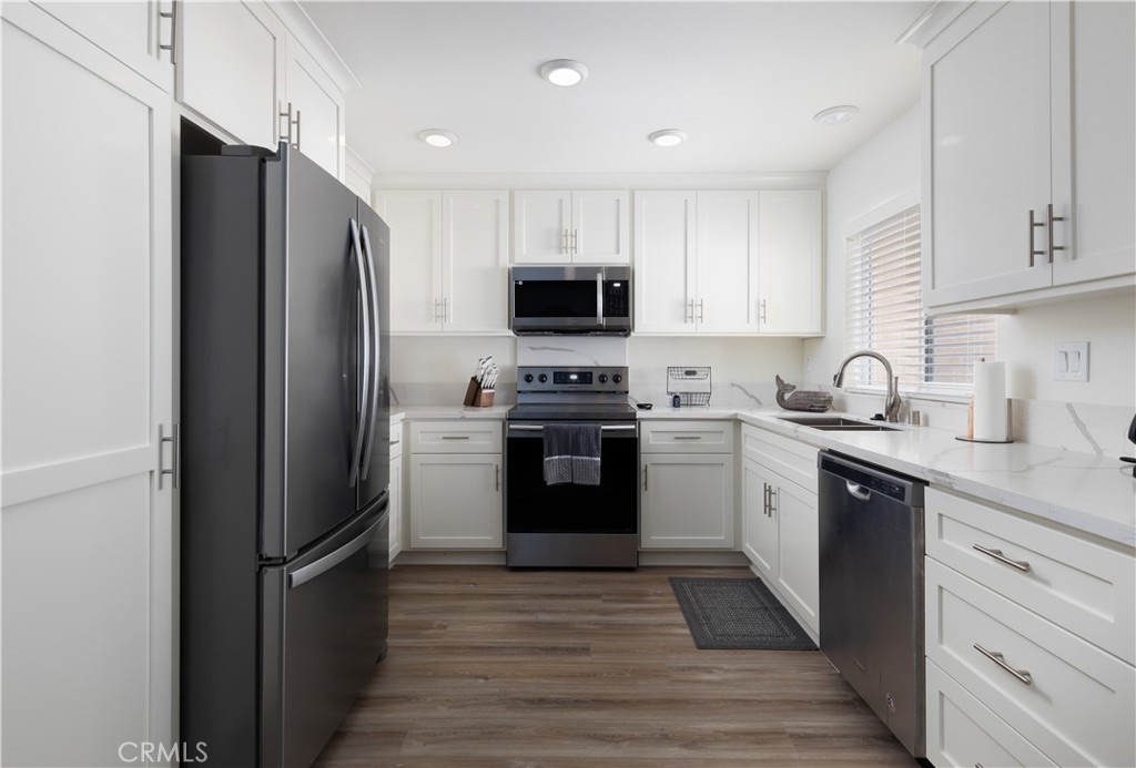 34116 Selva Road, Unit 308 Dana Point, CA 92629 - Photo 12 of 29 a kitchen with a refrigerator stove and sink