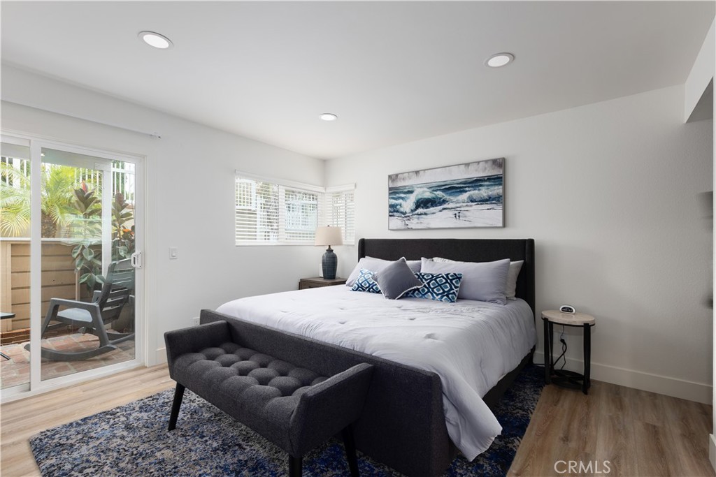 34116 Selva Road, Unit 308 Dana Point, CA 92629 - Photo 17 of 29 a bedroom with a bed and wooden floor